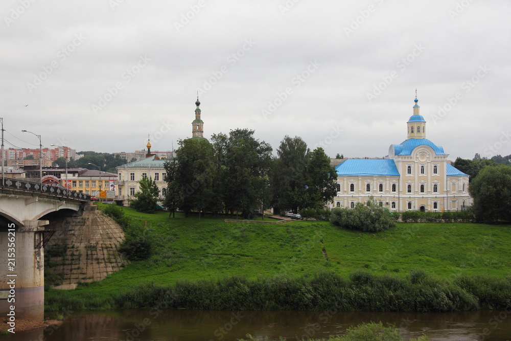 Russia, Smolensk, view from the Dnieper river embankment to the bridge and St. Nicholas Church on a cloudy day in summer