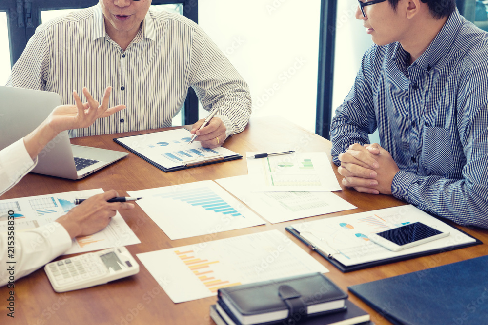 Group of teamwork businessman and woman in the meeting work to analysis marketing data concept business discussion , sepia yellow tone Group of teamwork businessman and woman in the meeting work to analysis marketing data concept business discussion , sepia yellow tone