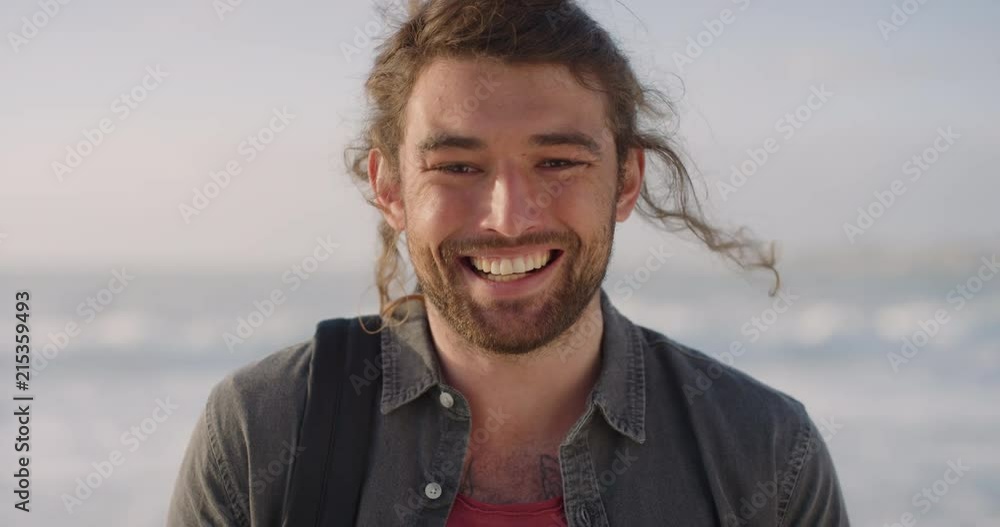 portrait of friendly young man smiling enjoying successful vacation lifestyle looking cheerful independent male on warm sunny beach portrait of friendly young man smiling enjoying successful vacation lifestyle looking cheerful independent male on warm sunny beach
