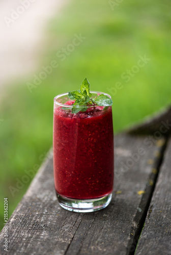 Raspberry smoothies with mint on rustic background