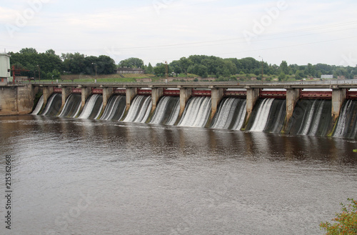 Water falls from a high dam hydroelectric plant into the river