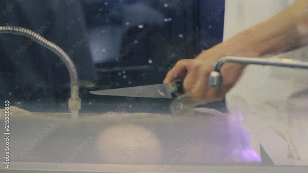 Chef cleaning white fish fillet at a Tokyo restaurant. Chef cleaning white fish fillet at a Tokyo restaurant.