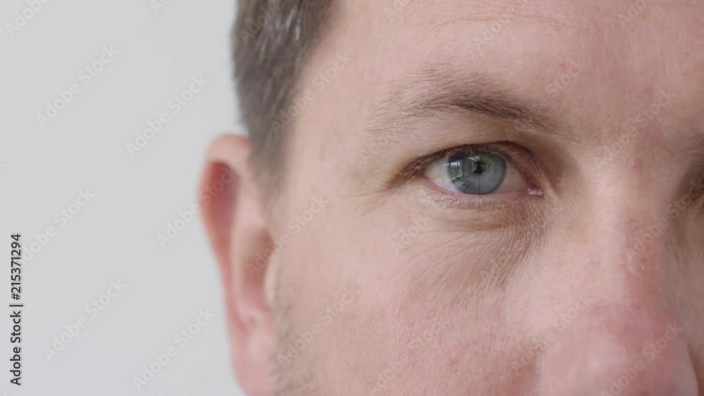 man blue eye looking at camera blinking pupil focus close up white background man blue eye looking at camera blinking pupil focus close up white background