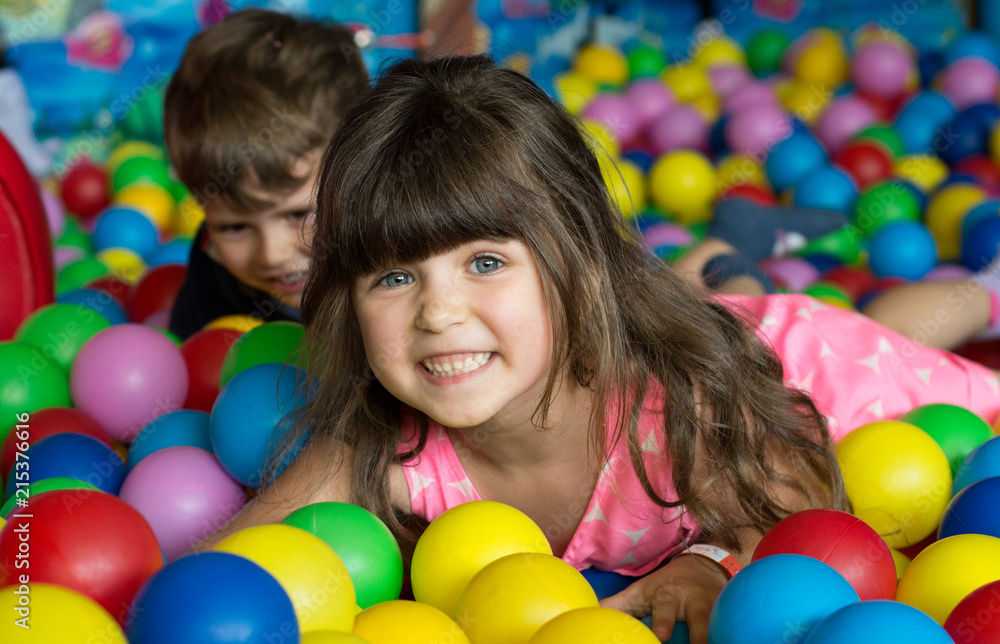 Happy children having fun at kids indoor play center. Kids playing with