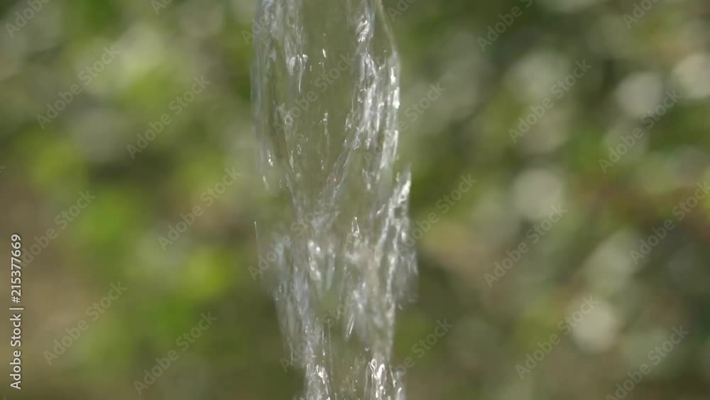 Slow motion of water flowing out of a water tap. Close-up. Slow motion of water flowing out of a water tap. Close-up.