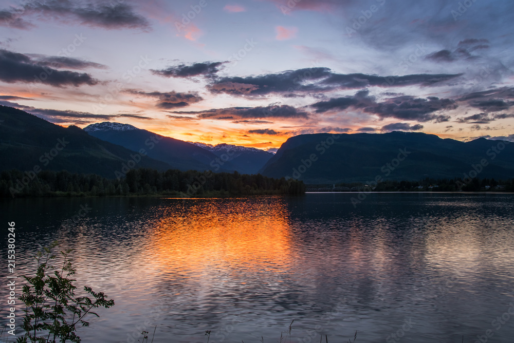 Spring Sunset over the Mountains and the Columbia River in Revelstoke, BC, Canada.