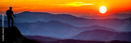 silhouette Of Hiker Watching Sunset Over Mountains © Philip Steury