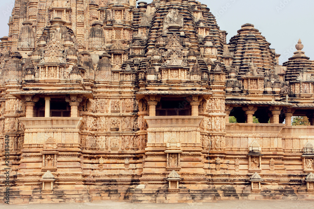 Stone walls of designed in 10th century Hindu temple in ancient Indian city Khajuraho. UNESCO World Heritage Site.