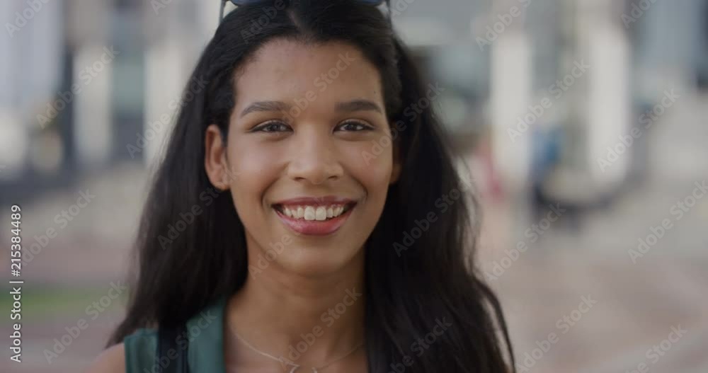 close up portrait beautiful young mixed race woman smiling happy in city slow motion close up portrait beautiful young mixed race woman smiling happy in city slow motion