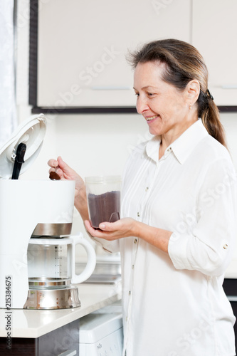 woman preparing coffee for breakfast.