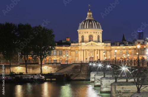 The night view of Seine river, Institut de France and bridge of Arts at night, Paris.