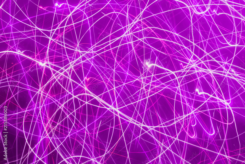 Blurred colorful lights in motion. Abstract background in purple tones