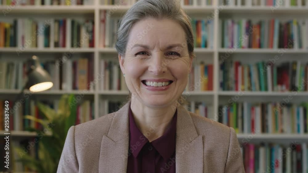 close up portrait of happy mature business woman executive smiling enjoying successful corporate career in bookshelf background close up portrait of happy mature business woman executive smiling enjoying successful corporate career in bookshelf background