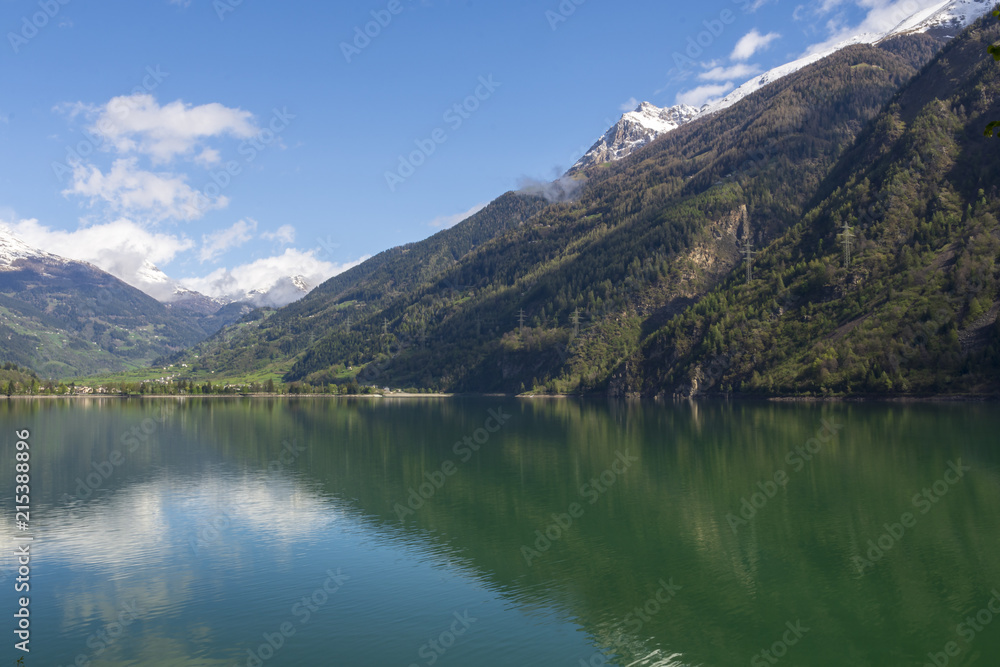 View ower lake Lago di poschiavo with calm turquoise water