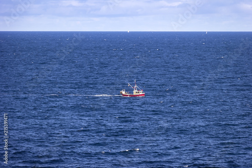 A small fishing boat rides rough on the North Atlantic
