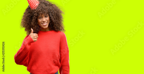 African american woman celebrates birthday happy with big smile doing ok sign, thumb up with fingers, excellent sign
