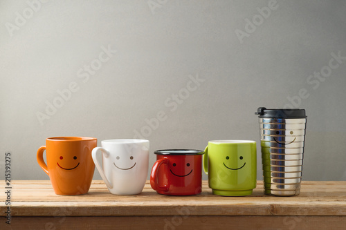 Many diifferent coffee cups on wooden table