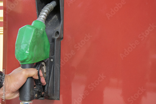 Close-up of a men's hand using a fuel nozzle