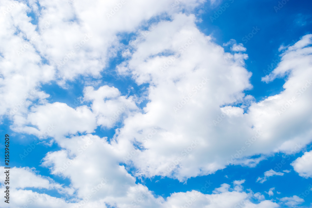 Fluffy White Cumulus Clouds and blue sky background and texture