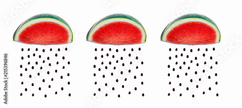 Watermelons and seeds rain concept on a white bakcground