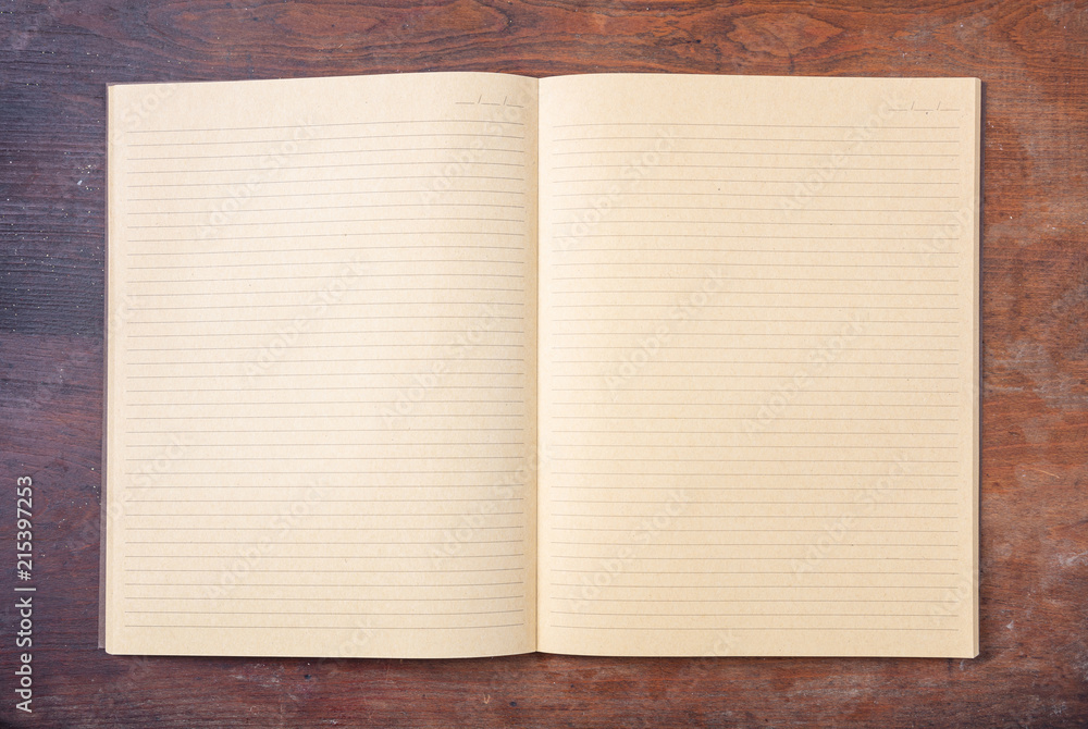 Open blank school notebook or diary, old fashioned, on wooden desk, space for text, top view Open blank school notebook or diary, old fashioned, on wooden desk, space for text, top view