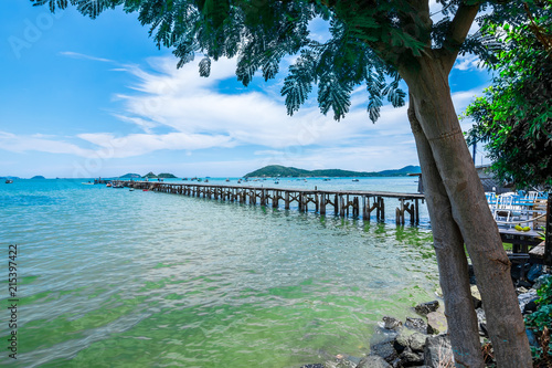 View of old wooden jetty along with the sea from the point under tree at Sattahip  Chonburi province  Thailand  