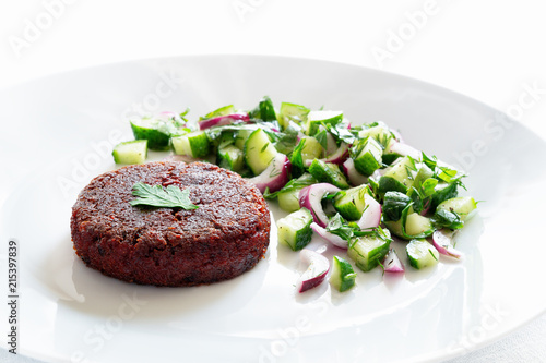 beetroot patty with cucumber, herbs, and onion salad