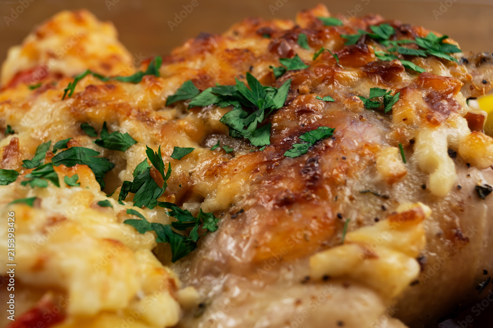 Chicken meat, baked in the oven with cheese and vegetables, decorated with finely chopped parsley. Chicken meat, baked in the oven with cheese and vegetables, decorated with finely chopped parsley.