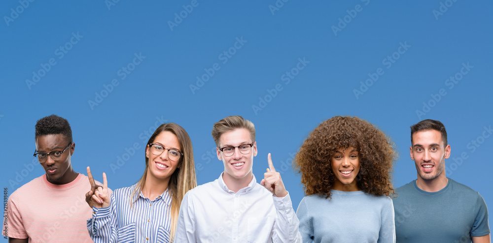 Composition of group of friends over blue blackground showing and pointing up with finger number one while smiling confident and happy. Composition of group of friends over blue blackground showing and pointing up with finger number one while smiling confident and happy.
