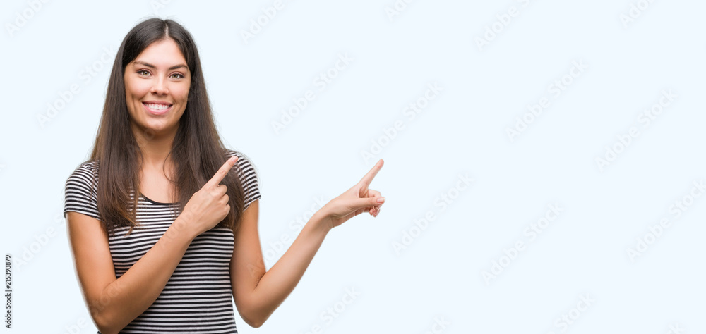 Young beautiful hispanic woman smiling and looking at the camera pointing with two hands and fingers to the side. Young beautiful hispanic woman smiling and looking at the camera pointing with two hands and fingers to the side.