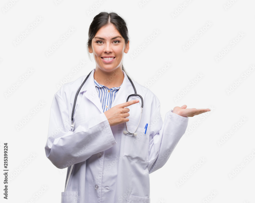 Young hispanic doctor woman very happy pointing with hand and finger Young hispanic doctor woman very happy pointing with hand and finger