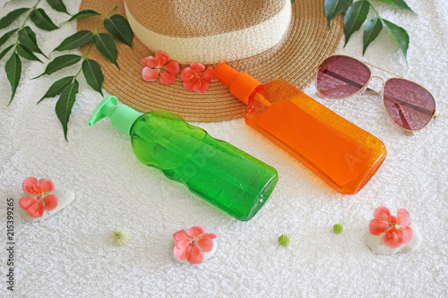 Straw hat with skin care products on white background. Holiday concept 