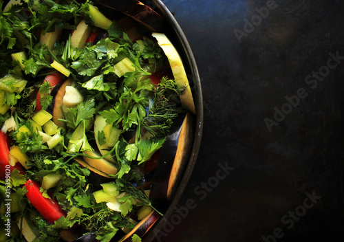 Ratatouille - french vegetarian dish made of zucchini, eggplants, peppers, onions, garlic and tomatoes with aromatic herbs. Traditional french food