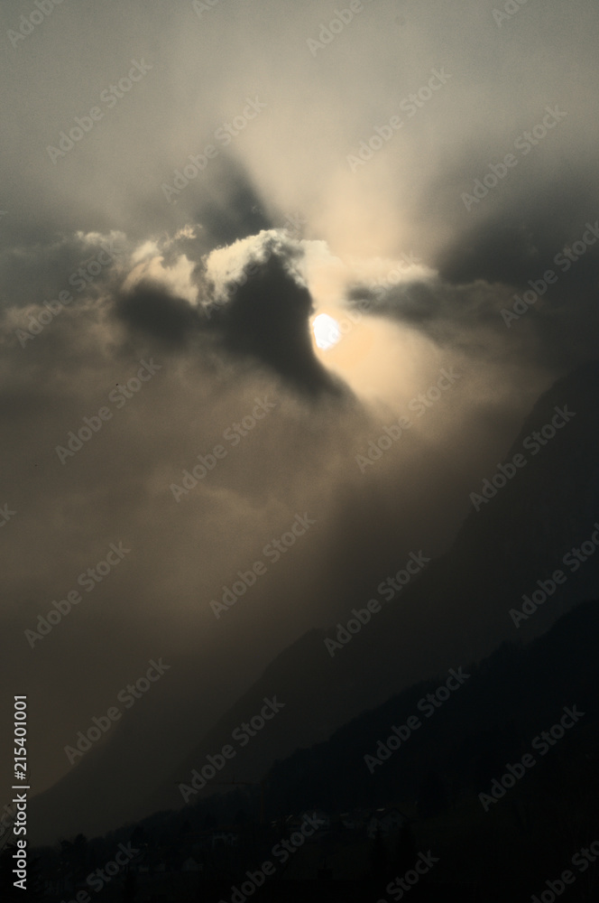 Sunburst over Rüthi; moody light as the Sun disappears in cloud over the Hoher Kasten