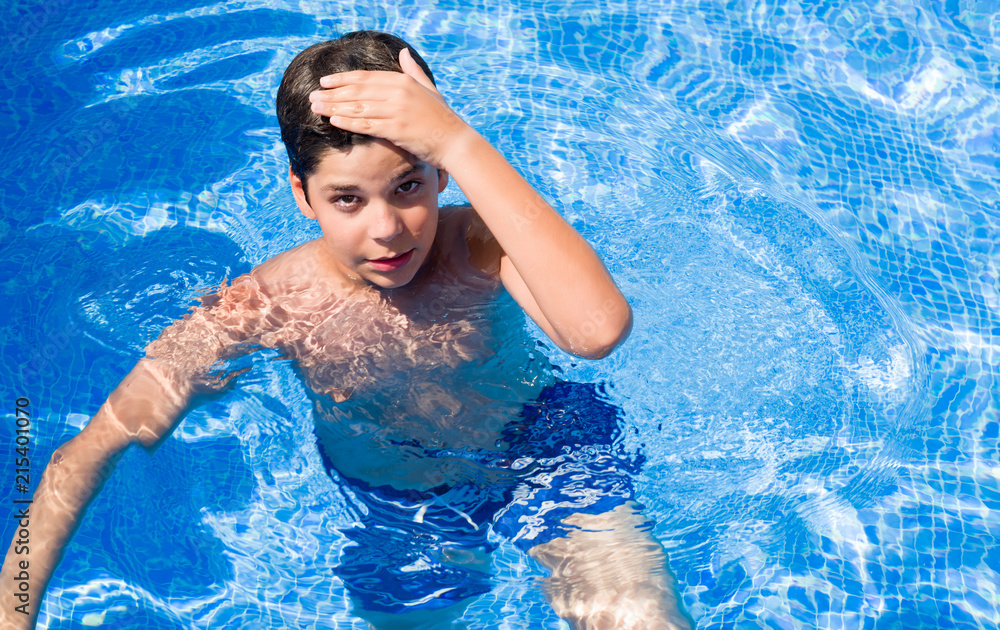 Young child on holidays at the swimming pool by the beach stressed with hand on head, shocked with shame and surprise face, angry and frustrated. Fear and upset for mistake.
