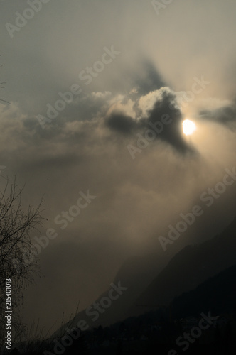 Sunburst over Rüthi; moody light as the Sun disappears in cloud over the Hoher Kasten