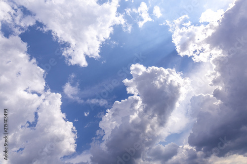 cloudscape with blue sky and shining sun
