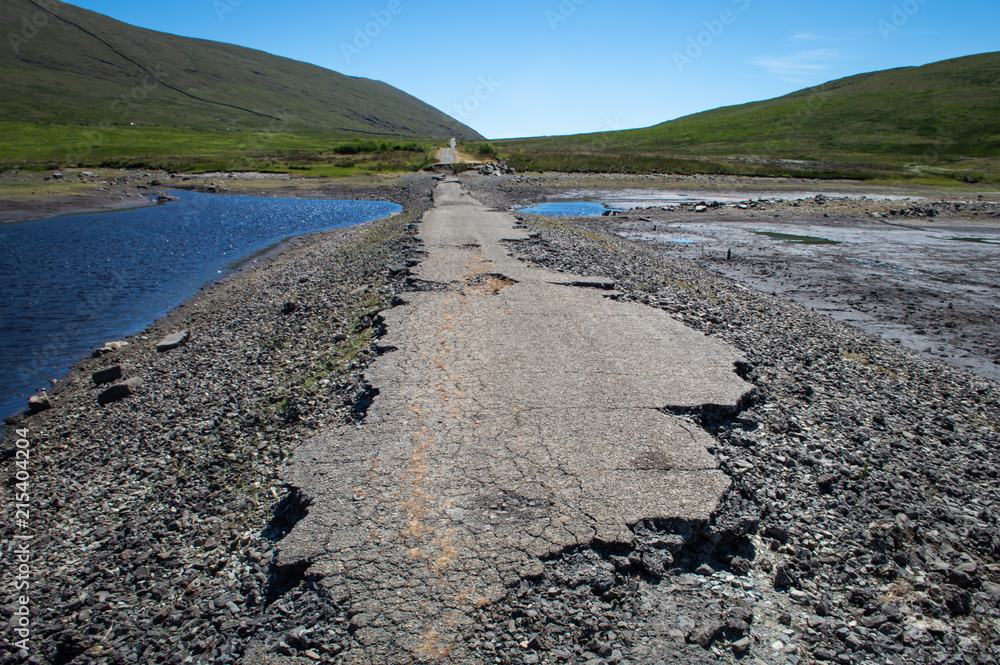 The low level of water in a reservoir exposes an old road