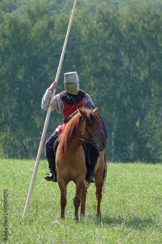 medieval knight with a spear riding a horse