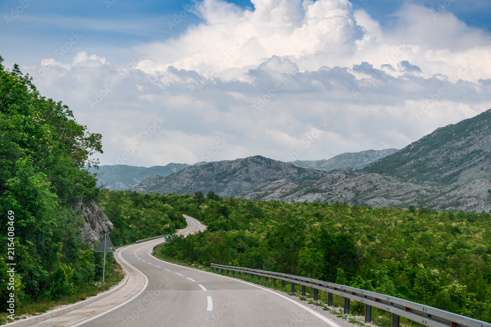 Concept picture of road trip in Montenegro, beautiful road pass through the greenery & stone mountain