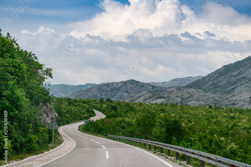 Concept picture of road trip in Montenegro  beautiful road pass through the greenery   stone mountain