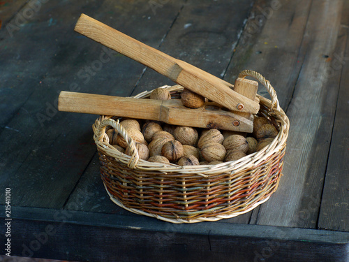 Nutcracker in a basket with walnuts. photo