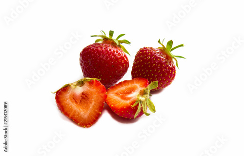 Strawberry with sliced half and leaves isolated on white background with clipping path. Strawberry whole and cut into halves. Close-up. Red strawberries.