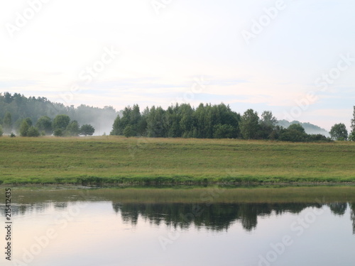 evening clouds on the river after sunset © Andrey