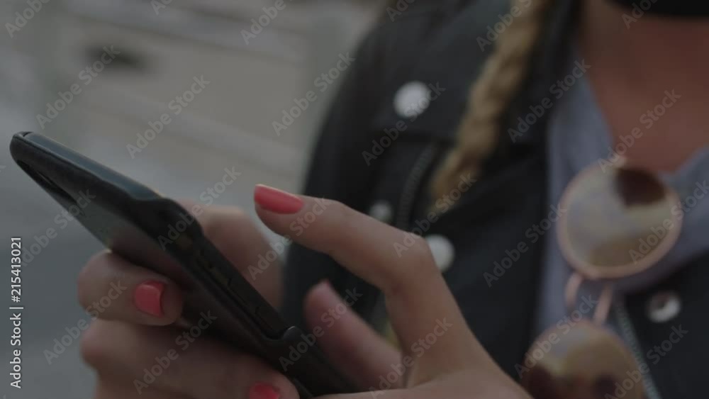close up portrait of attractive blonde woman using phone texting looking around waiting in seaside close up portrait of attractive blonde woman using phone texting looking around waiting in seaside
