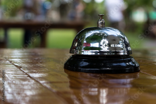 Stainless steel ringing bell on the wooden table