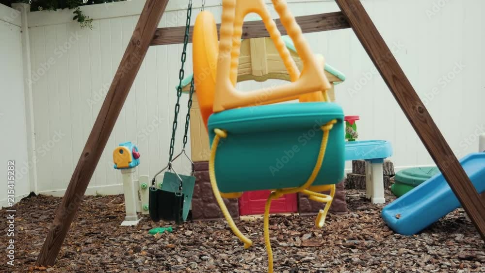 side view of swingset and playground with movement side view of swingset and playground with movement