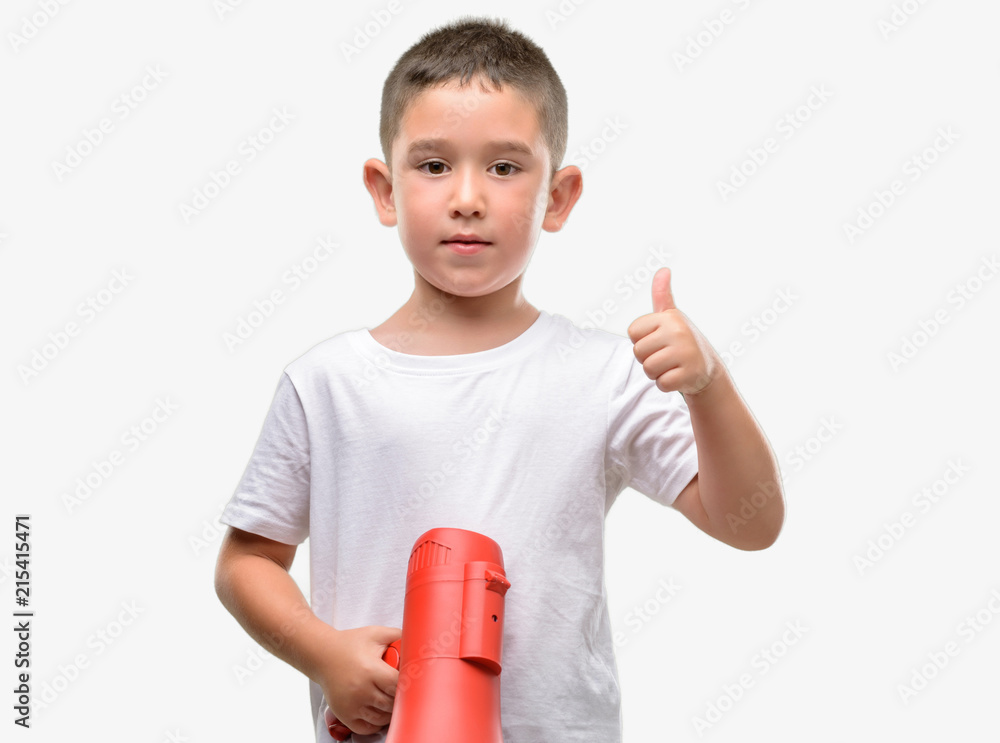 Dark haired little child holding megaphone happy with big smile doing ok sign, thumb up with fingers, excellent sign Dark haired little child holding megaphone happy with big smile doing ok sign, thumb up with fingers, excellent sign