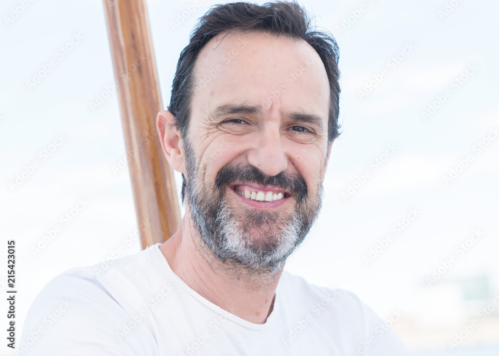 Handsome senior man traveling on sailboat and smiling happy and confident Handsome senior man traveling on sailboat and smiling happy and confident