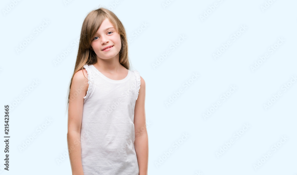Young blonde toddler with a happy face standing and smiling with a confident smile showing teeth Young blonde toddler with a happy face standing and smiling with a confident smile showing teeth